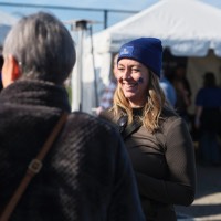 Woman smiling with GV tattoo on cheek